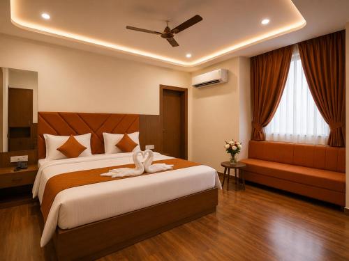a bedroom with a large bed and a ceiling fan at Hotel Grand Lucent Mathura-Vrindavan in Gokul