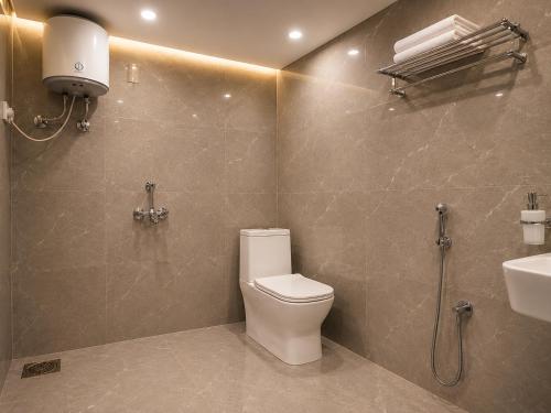 a bathroom with a toilet and a sink at Hotel Grand Lucent Mathura-Vrindavan in Gokul