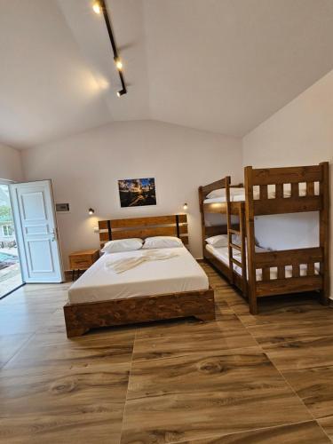 a bedroom with two bunk beds in a room at Bungalows at Mali Camp Kruje with Pool in Krujë