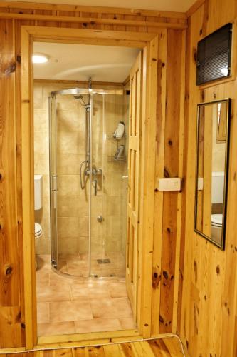 a bathroom with a shower with a glass door at Kucica Enterprise-Ada Bojana in Ulcinj