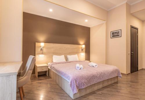a bedroom with a bed with two towels on it at Seti Mestia Hotel in Mestia