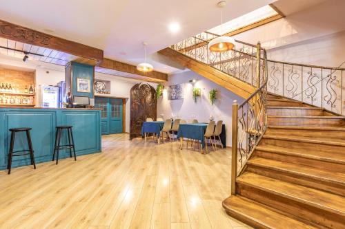 a staircase in a room with a table and a bar at Seti Mestia Hotel in Mestia