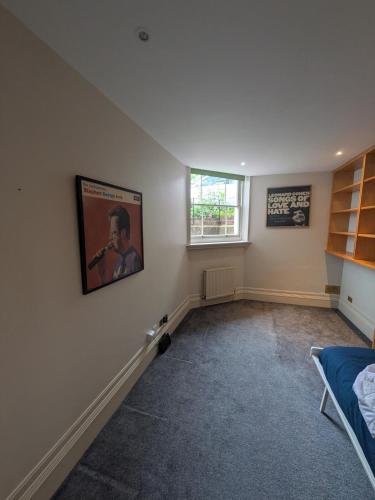 a bedroom with a picture of a man on the wall at Hidden get away in Lewes in Lewes
