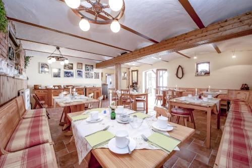 a dining room with wooden tables and chairs at Landhaus Brodack in Alt Zauche