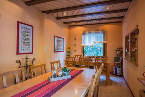 a kitchen and dining room with a table and chairs at Pension Haus Brückner in Wildemann