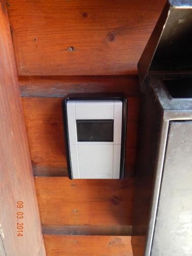 a microwave sitting inside of a wooden wall at Schlupfwinkel Mohnen Mit E-Ladestation in Clausthal-Zellerfeld