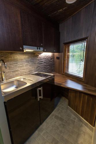 a kitchen with a sink and a counter top at Hotel Krapi in Tuusula