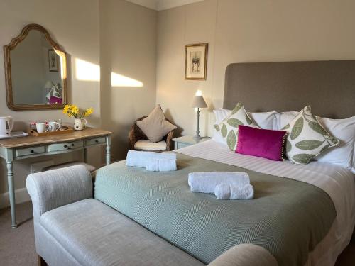 a bedroom with a large bed with two towels on it at Halton Red House Farm in Stagshaw Bank