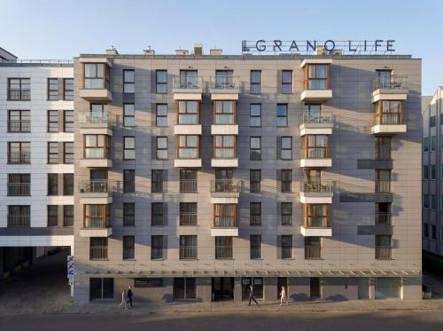 a building with a sign on the front of it at GRANO LIFE Gdańsk in Gdańsk