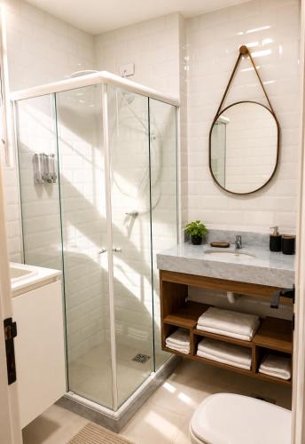 a bathroom with a shower and a toilet and a sink at Apartamento Nictheroy in Niterói