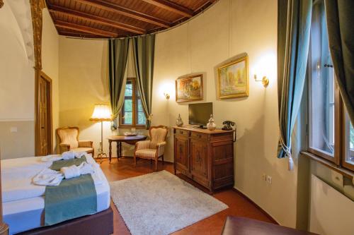 a bedroom with a bed and a table and chairs at Hotel Jagdschloss Letzlingen in Letzlingen