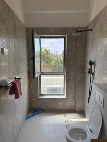 a bathroom with a toilet and a window at שחף על הכנרת in HaOn