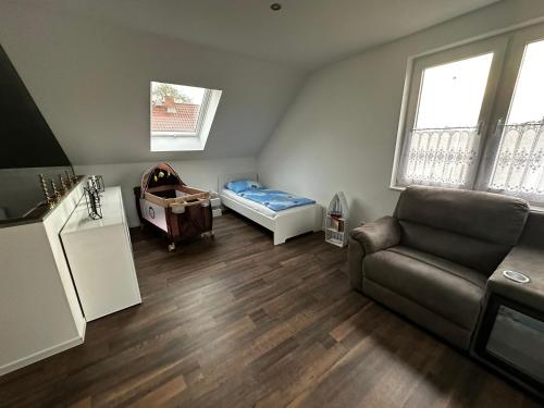 a living room with a couch and a bed at Ferienhaus Kronseeliebe in Lychen
