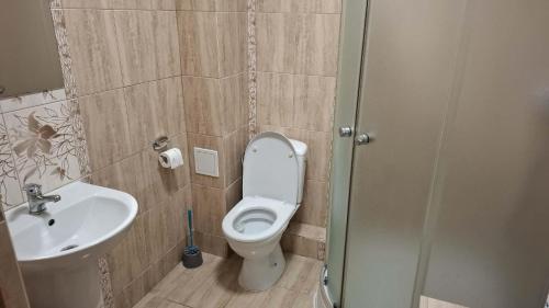 a bathroom with a toilet and a sink at Dom Studenta PUZ w Suwałkach in Suwałki