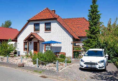 a white car parked in front of a house at Ferienwohnung Maltzahn & Beese in Jabel