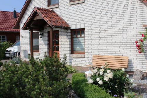 a wooden bench in front of a house at Ferienwohnung Maltzahn & Beese in Jabel