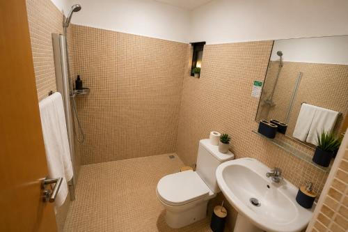 a bathroom with a toilet and a sink at Viana Hotel in Luanda
