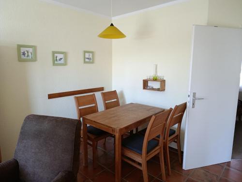 a dining room with a wooden table and chairs at Hermannstr 14-Whg 10 in Kühlungsborn