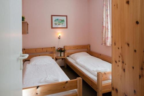 a room with two beds in a room with a window at Störtebeker 07 in Kühlungsborn