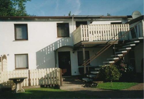 a house with a staircase in front of it at Ück - Biedenweg in Ueckeritz