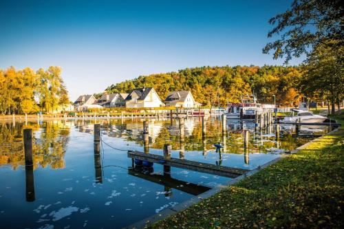 a marina with a bunch of houses on a lake at Ück - Biedenweg in Ueckeritz