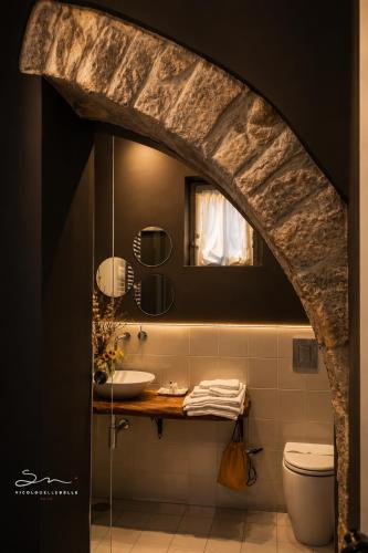 a bathroom with a sink and a toilet at Vicolo delle Belle Suite in Terracina