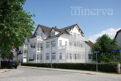 a large white building with balconies on a street at "Villa Minerva" Ferienwohnung 09 in Kühlungsborn