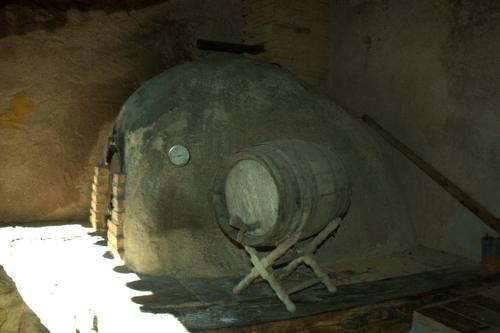 a large barrel sitting inside of a cave at Casas Arbillas in Arenas de San Pedro