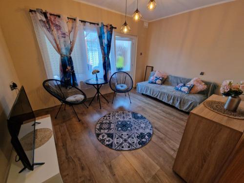 a living room with a couch and a table at POD SOSNAMI - ul Dominicka 28 in Boszkowo