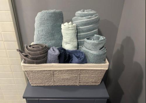 a basket filled with towels on a shelf in a bathroom at Maxis-place in Jersey City