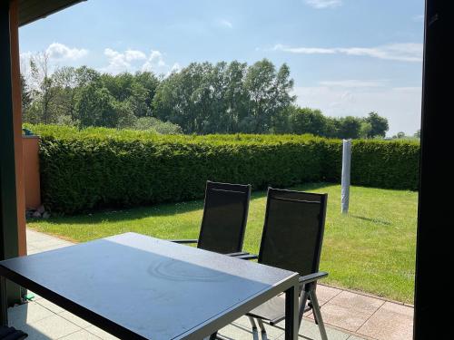 a table and two chairs sitting on a patio at Rügen Fewo 211 in Parchtitz