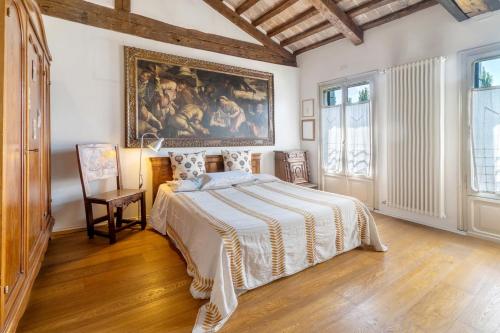 a bedroom with a bed and a painting on the wall at Villa Colloredo in Dolo