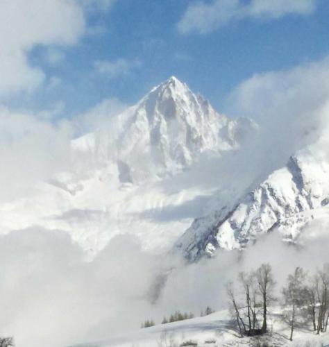 a mountain covered in snow with clouds in front of it at Stalu D1 - Bürchen in Bürchen