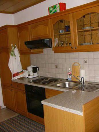 a kitchen with a sink and a stove top oven at Ferienwohnungen Hauerperle in Neudörfl