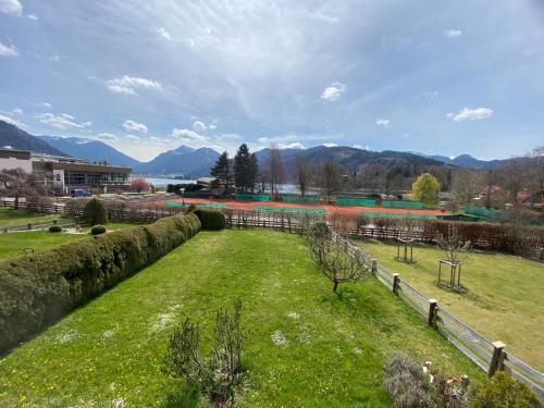 a field of grass with mountains in the background at Haus St_ Michael_ Ferienwohnung 1_4 in Schliersee
