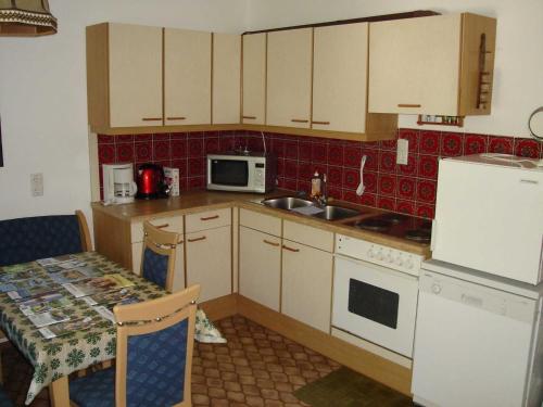 a small kitchen with a sink and a stove at Ferienwohnung Jirkal in Sankt Martin bei Lofer