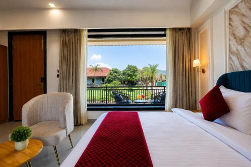 a hotel room with a bed and a large window at Vijay Vilas by Arow Hotels and Resorts in Pushkar