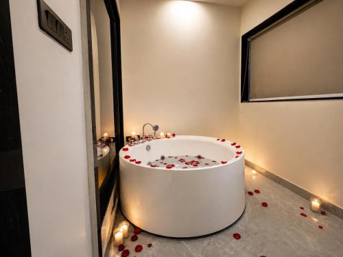 a bathroom with a white tub with roses on the floor at Vijay Vilas by Arow Hotels and Resorts in Pushkar