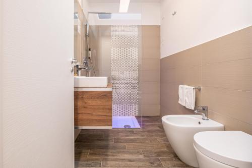 a bathroom with a sink and a toilet and a shower at Villaggio Poseidone Beach Resort - Hotel in Torre San Giovanni Ugento