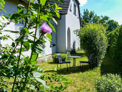 a table and chairs in the yard of a house at Ferienwohnung Alte Dorfschule in Lüssow