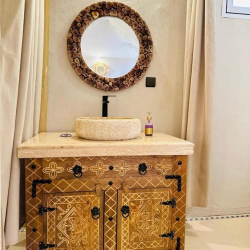 a bathroom with a sink and a mirror at Sunny Luxury Camp in Merzouga