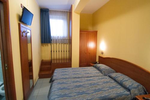 a bedroom with a bed and a television in it at Pensione Al Pescatore in Termoli