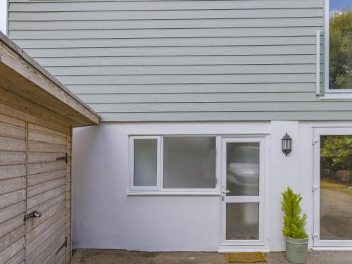 a house with a white door and a garage at Kingsleys Lodge in Barnstaple