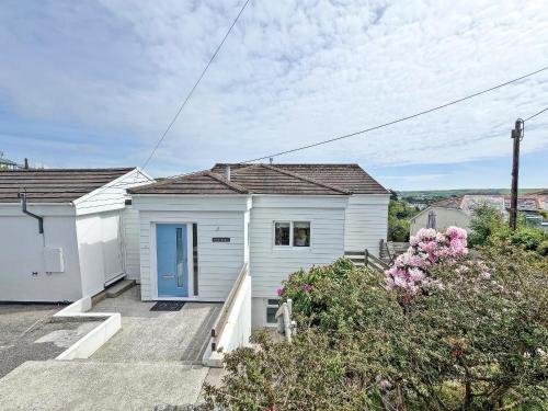 a white house with a blue door at Whitestones in Saint Mawes
