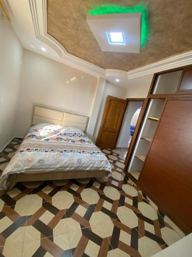 a bedroom with a bed and a ceiling at Perle de Soliman Plage in Soliman