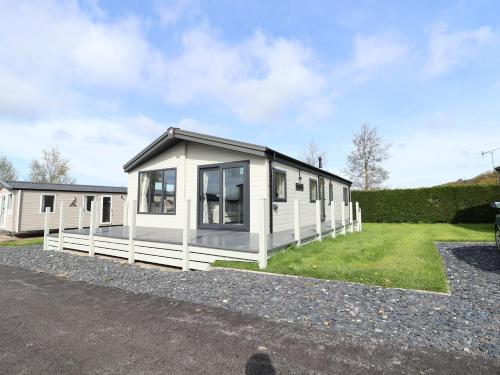 a small white house with a black roof at White House in St Asaph