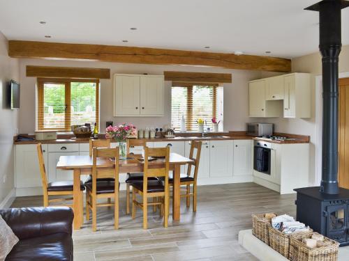 a kitchen with a table and chairs and a stove at The Granary in Pendleton