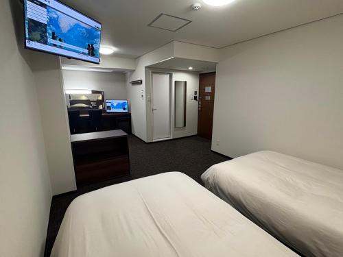 Кровать или кровати в номере Hotel Alpha-One Iwaki