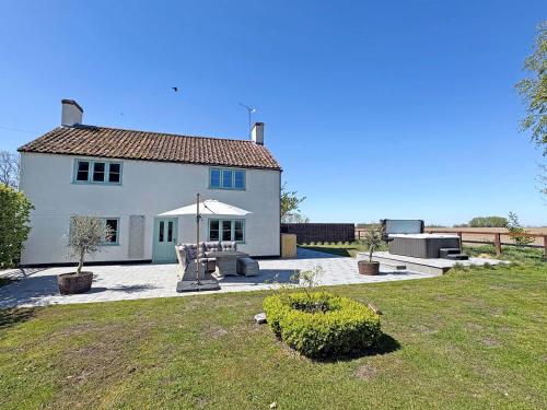 a white house with a patio and a yard at Hill House - Uk49727 in King's Lynn