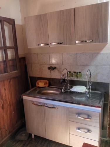 a small kitchen with a sink and a counter at K&M descanso y excursiones in Fiambalá